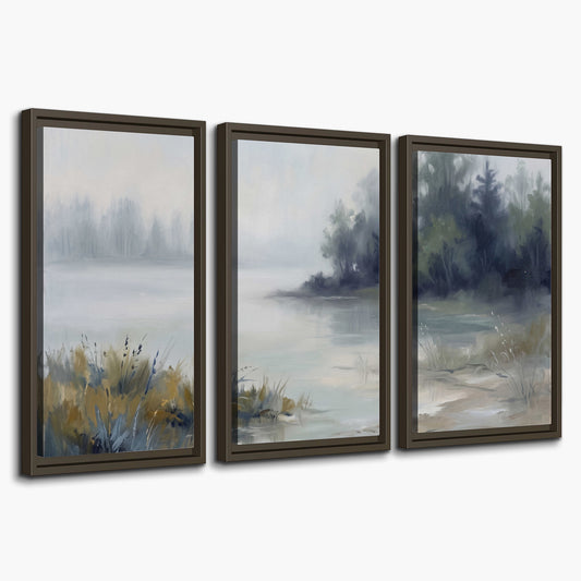 A calm pale lake bordered by dark evergreen trees and distant mist 3 piece framed canvas wall art on a white background