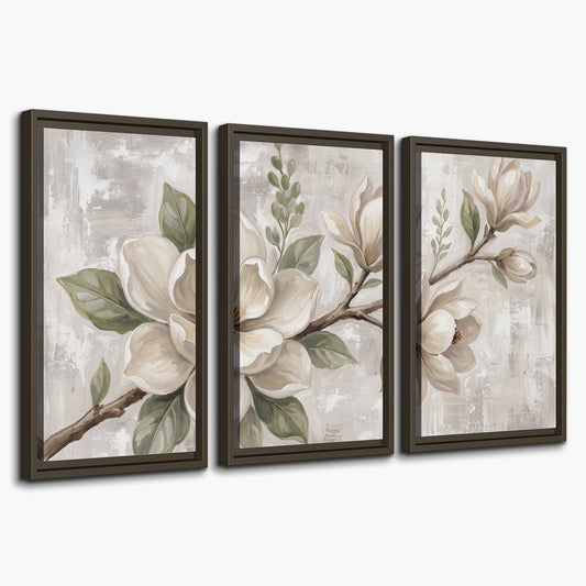 Large ivory magnolia blossoms and soft green leaves on pale gray 3 piece framed canvas wall art on a white background