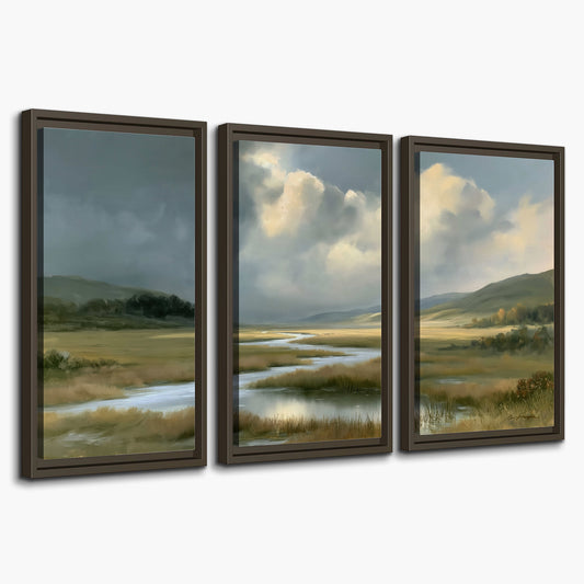 A winding stream through an open meadow beneath large sunlit clouds 3 piece framed canvas wall art on a white background