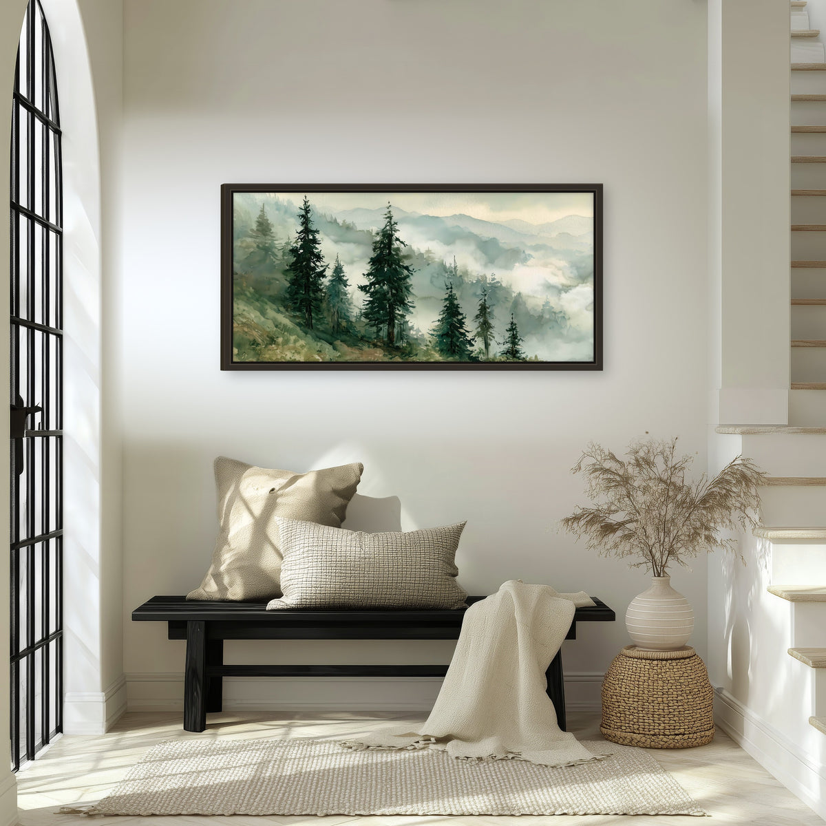 Misty mountain pines watercolor framed canvas wall art in an entryway above a bench