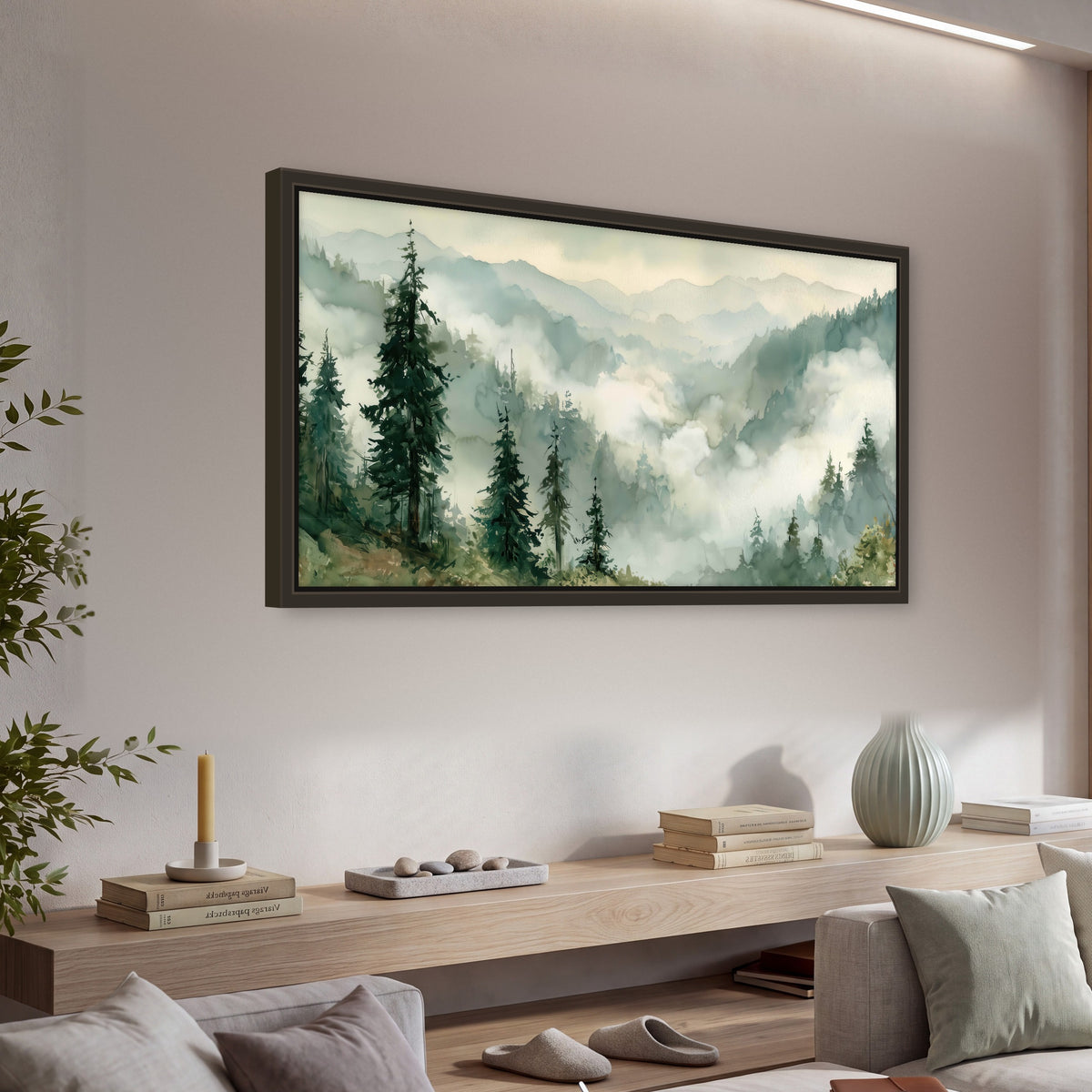 Watercolor misty mountain forest painting framed canvas wall art in a living room above a console