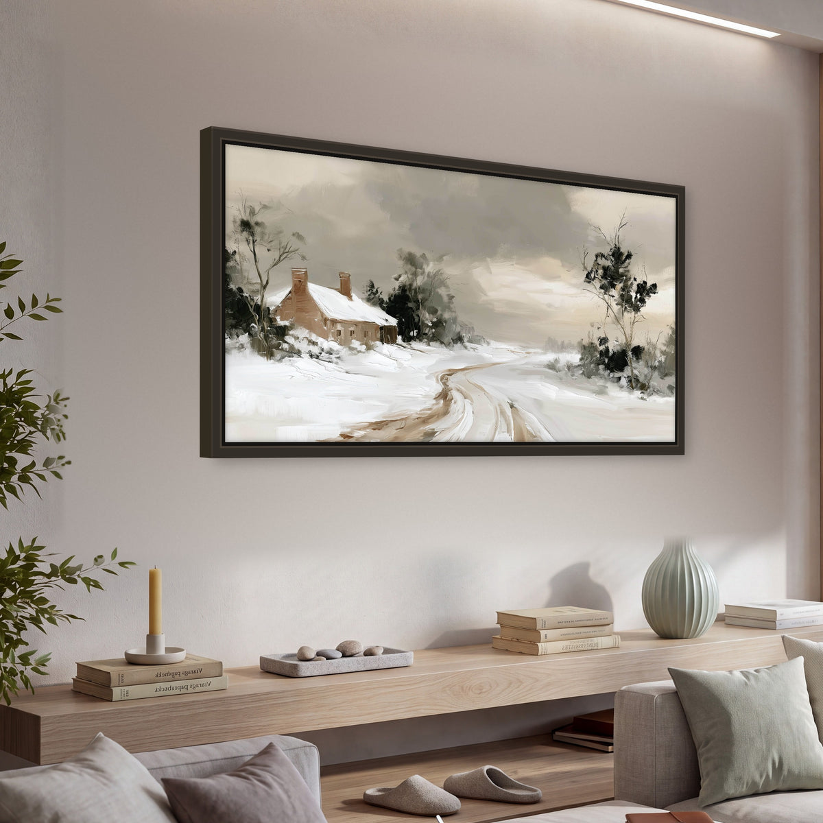 Neutral winter cottage painting framed canvas wall art in a living room above a console