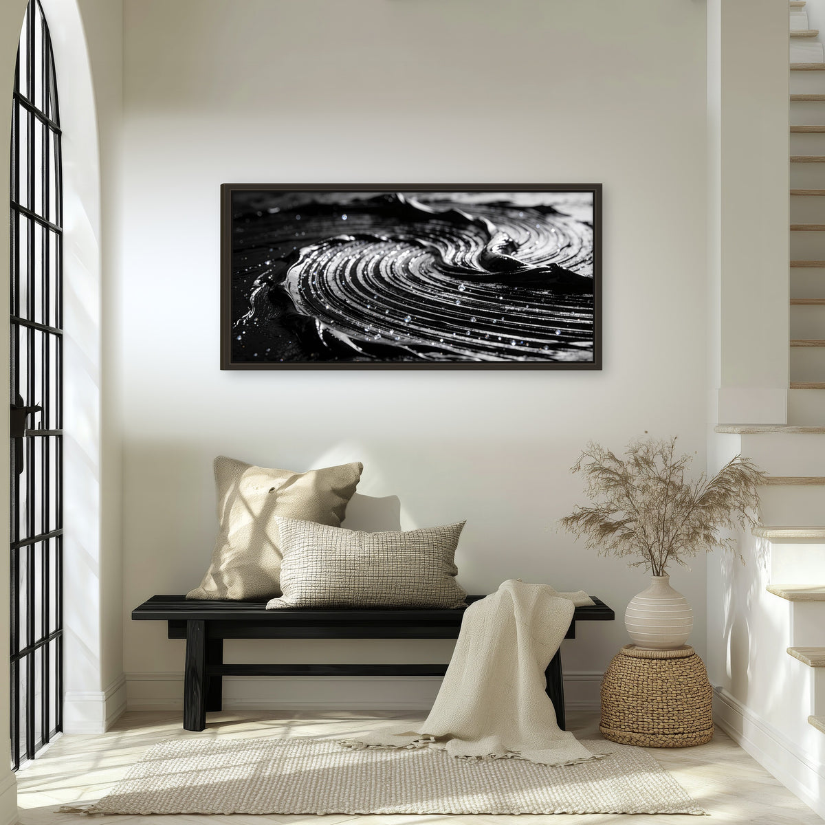 Black and silver swirl abstract painting framed canvas wall art in an entryway above a bench