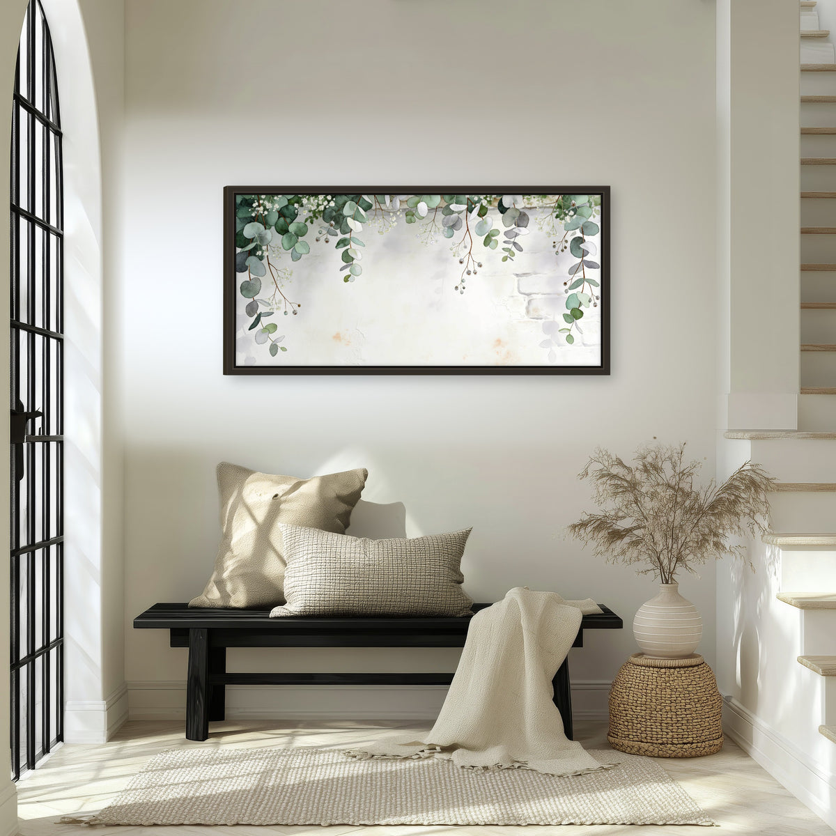 Watercolor eucalyptus greenery painting framed canvas wall art in an entryway above a bench