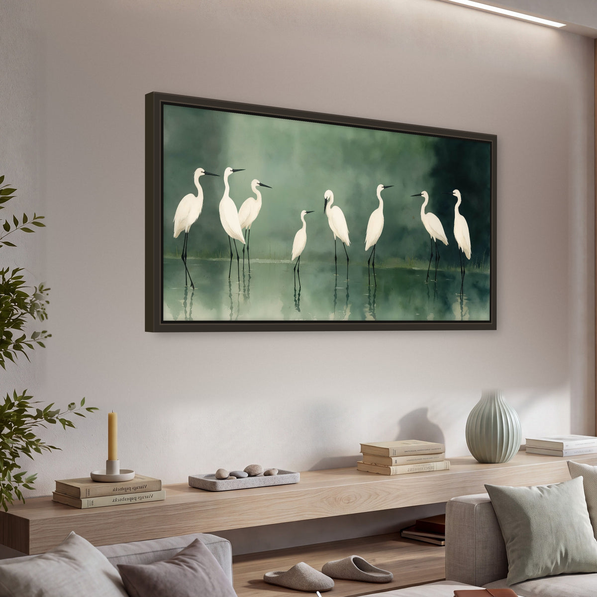 White egrets on green lake painting framed canvas wall art in a living room above a console