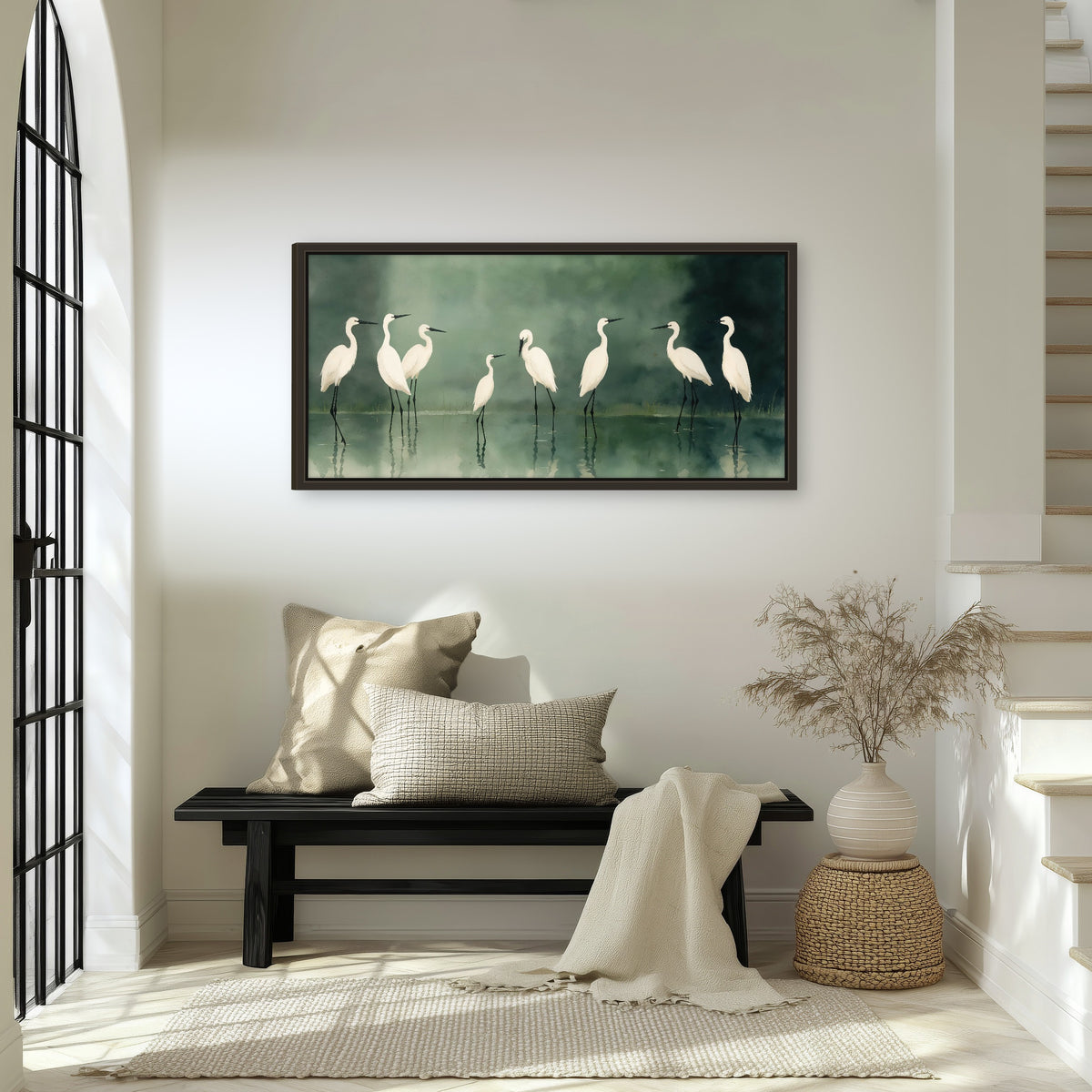 White egrets on green lake painting framed canvas wall art in an entryway above a bench