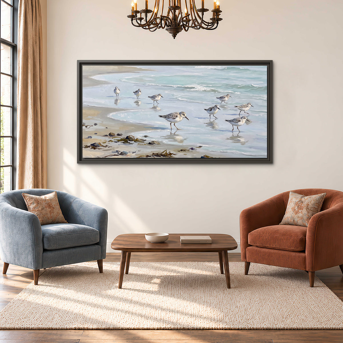 Small shorebirds standing along a pale blue shoreline single framed canvas wall art styled in an interior