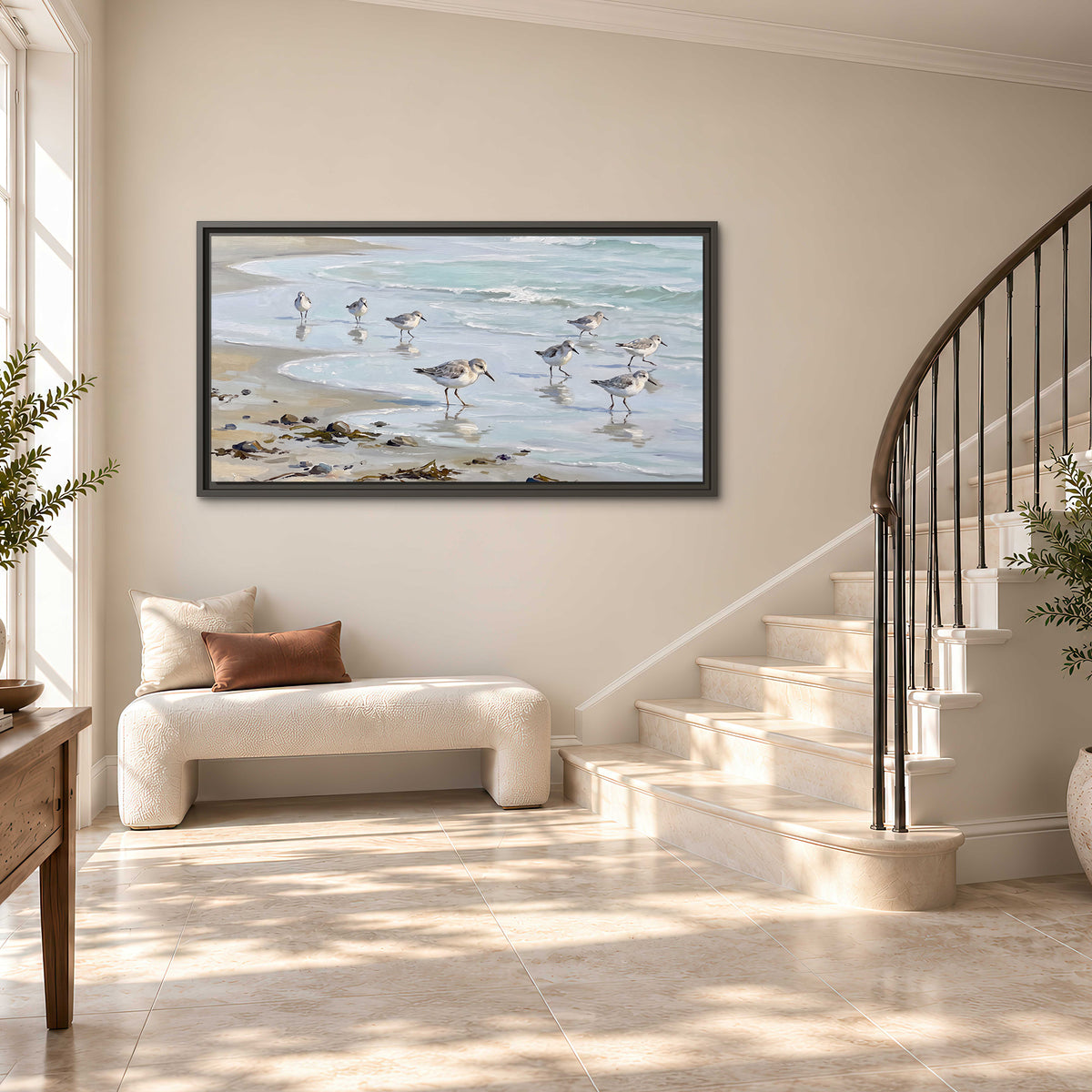 Small shorebirds standing along a pale blue shoreline single framed canvas wall art styled in an interior