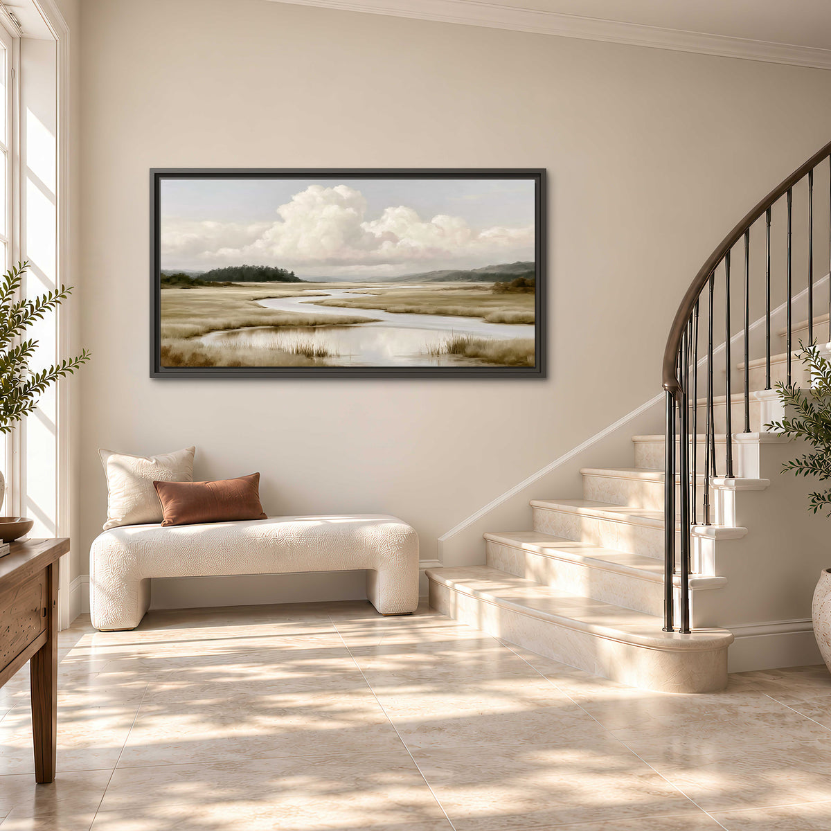 A pale winding waterway crossing quiet wetlands beneath billowing white clouds single framed canvas wall art styled in an interior