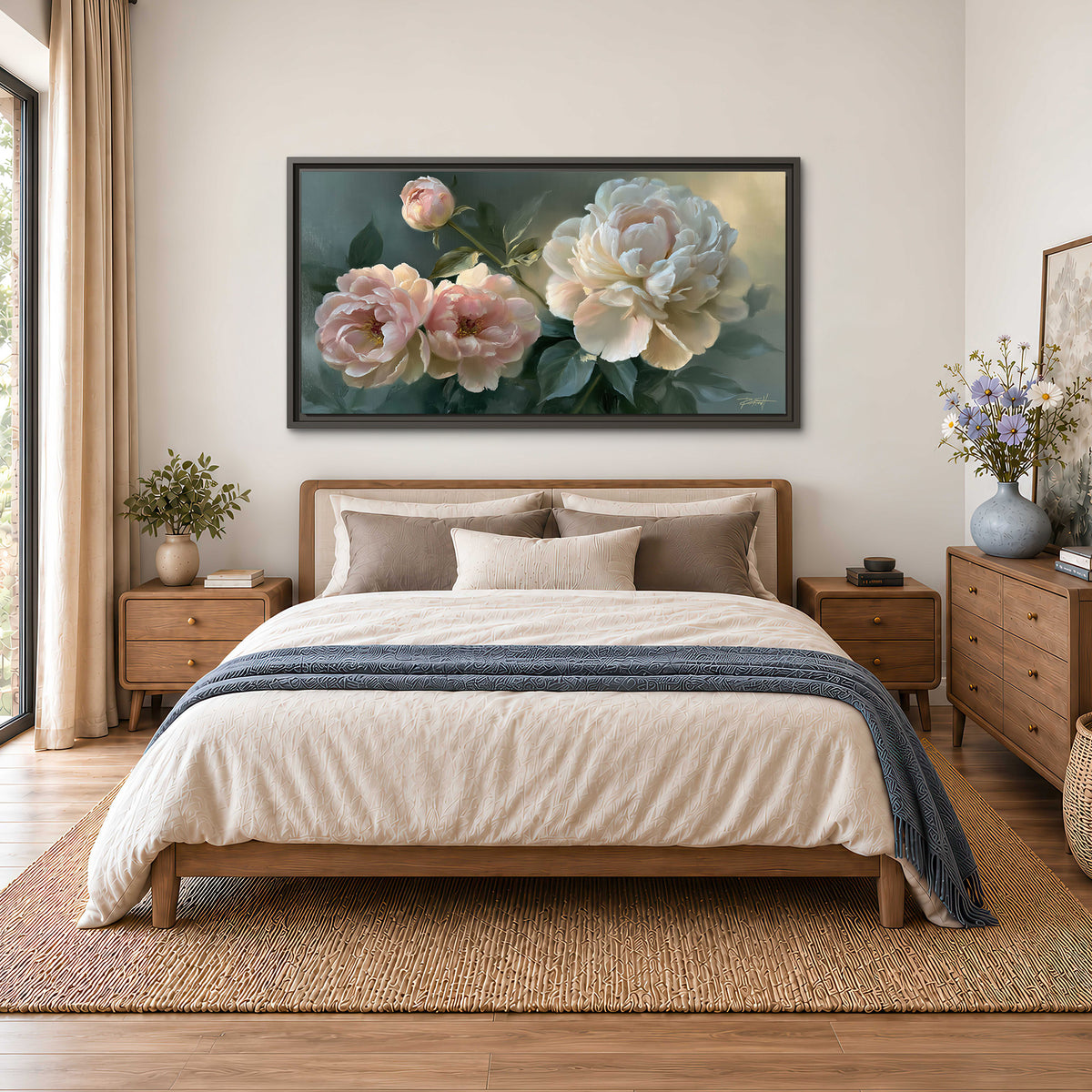 A large cream peony beside blush flowers and broad green leaves single framed canvas wall art styled in an interior