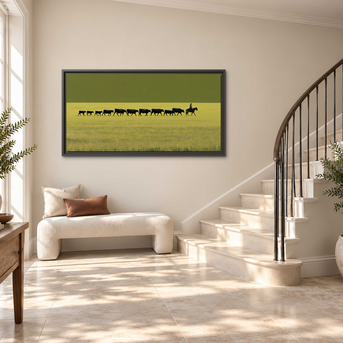 A rider leading a long line of cattle across a wide green and golden plain single framed canvas wall art styled in an interior