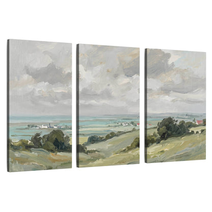 3 piece canvas wall art – coastal landscape with white cottages, green hills and cloudy sky