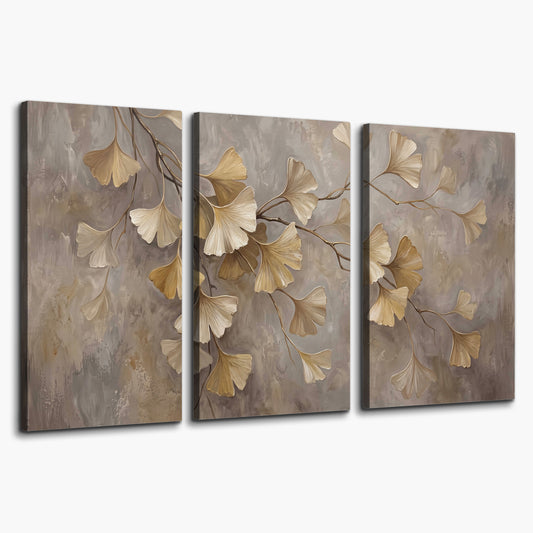 Cream and gold-colored ginkgo leaves against warm gray 3 piece canvas wall art on a white background