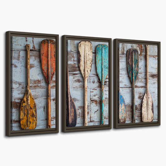 A row of colorful weathered wooden oars against pale blue boards 3 piece framed canvas wall art on a white background