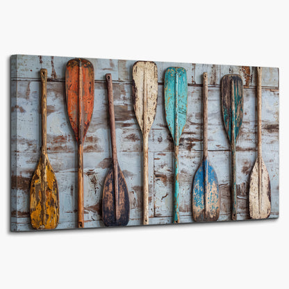 A row of colorful weathered wooden oars against pale blue boards single canvas wall art on a white background