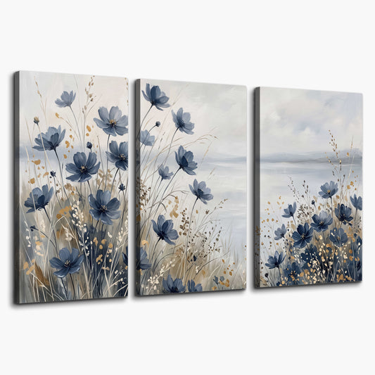 Soft blue flowers and ivory grasses beside a pale coastal horizon 3 piece canvas wall art on a white background