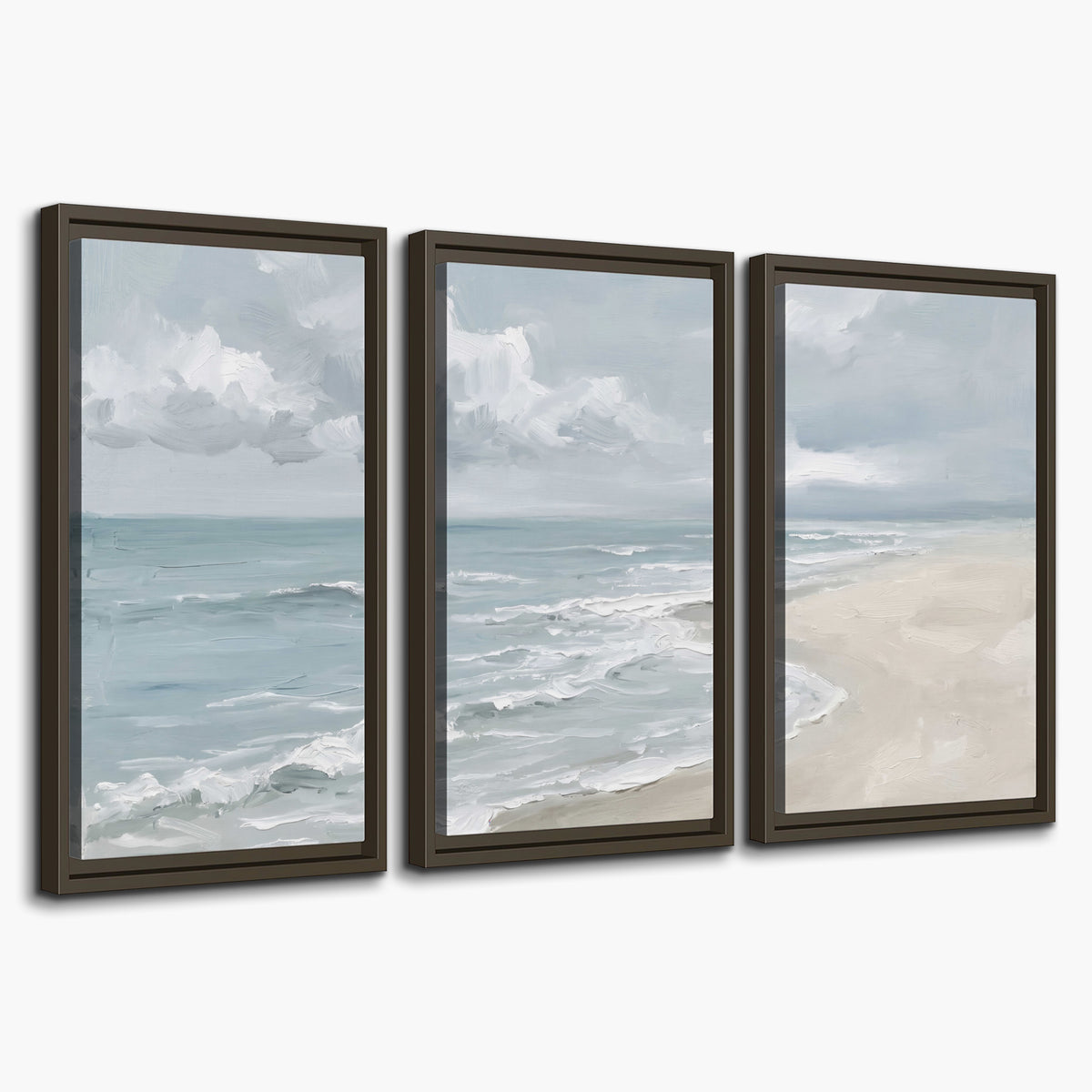 Gentle pale blue waves washing across a light sandy beach 3 piece framed canvas wall art on a white background