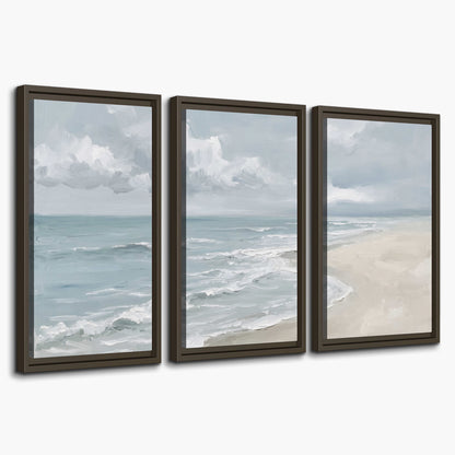 Gentle pale blue waves washing across a light sandy beach 3 piece framed canvas wall art on a white background