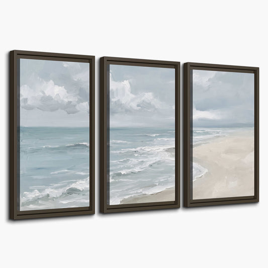 Gentle pale blue waves washing across a light sandy beach 3 piece framed canvas wall art on a white background