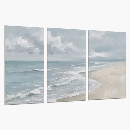 Gentle pale blue waves washing across a light sandy beach set of 3 poster prints on a white background