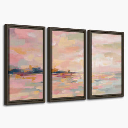 Pink, peach and yellow painted-style sky and water reflections 3 piece framed canvas wall art on a white background
