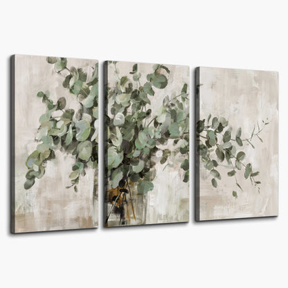 Soft sage eucalyptus leaves and pale stems on a warm cream background 3 piece canvas wall art on a white background