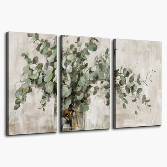 Soft sage eucalyptus leaves and pale stems on a warm cream background 3 piece canvas wall art on a white background