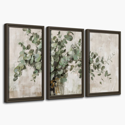 Soft sage eucalyptus leaves and pale stems on a warm cream background 3 piece framed canvas wall art on a white background