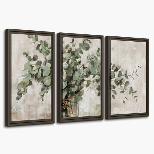 Soft sage eucalyptus leaves and pale stems on a warm cream background 3 piece framed canvas wall art on a white background