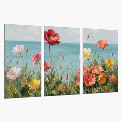 Colorful red, peach and yellow flowers beside a turquoise sea set of 3 poster prints on a white background