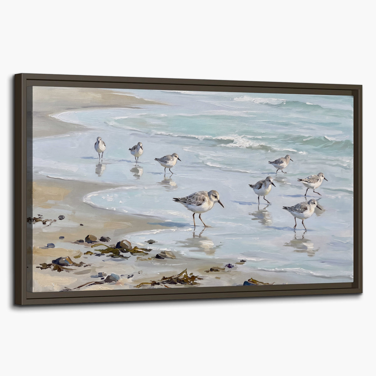 Small shorebirds standing along a pale blue shoreline single framed canvas wall art on a white background