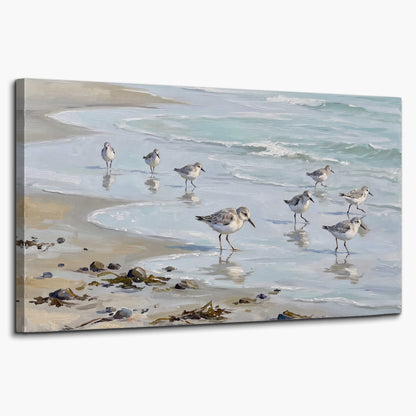 Small shorebirds standing along a pale blue shoreline single canvas wall art on a white background
