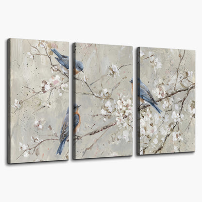 Bluebirds perched on delicate white flowering branches against pale sage 3 piece canvas wall art on a white background