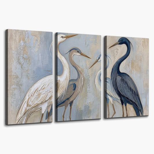 Three long-necked herons in soft ivory and dark blue against pale blue-gray 3 piece canvas wall art on a white background