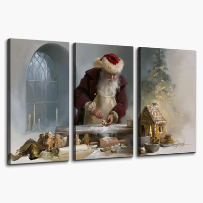 Santa working with dough beside a gingerbread house in a softly lit Christmas kitchen 3 piece canvas wall art on a white background