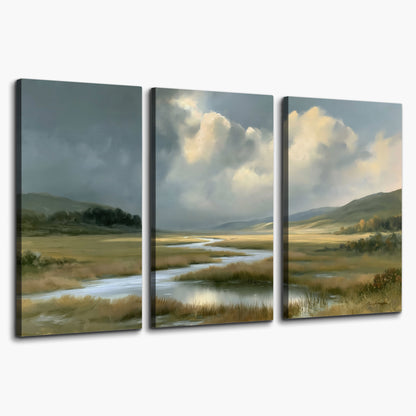 A winding stream through an open meadow beneath large sunlit clouds 3 piece canvas wall art on a white background