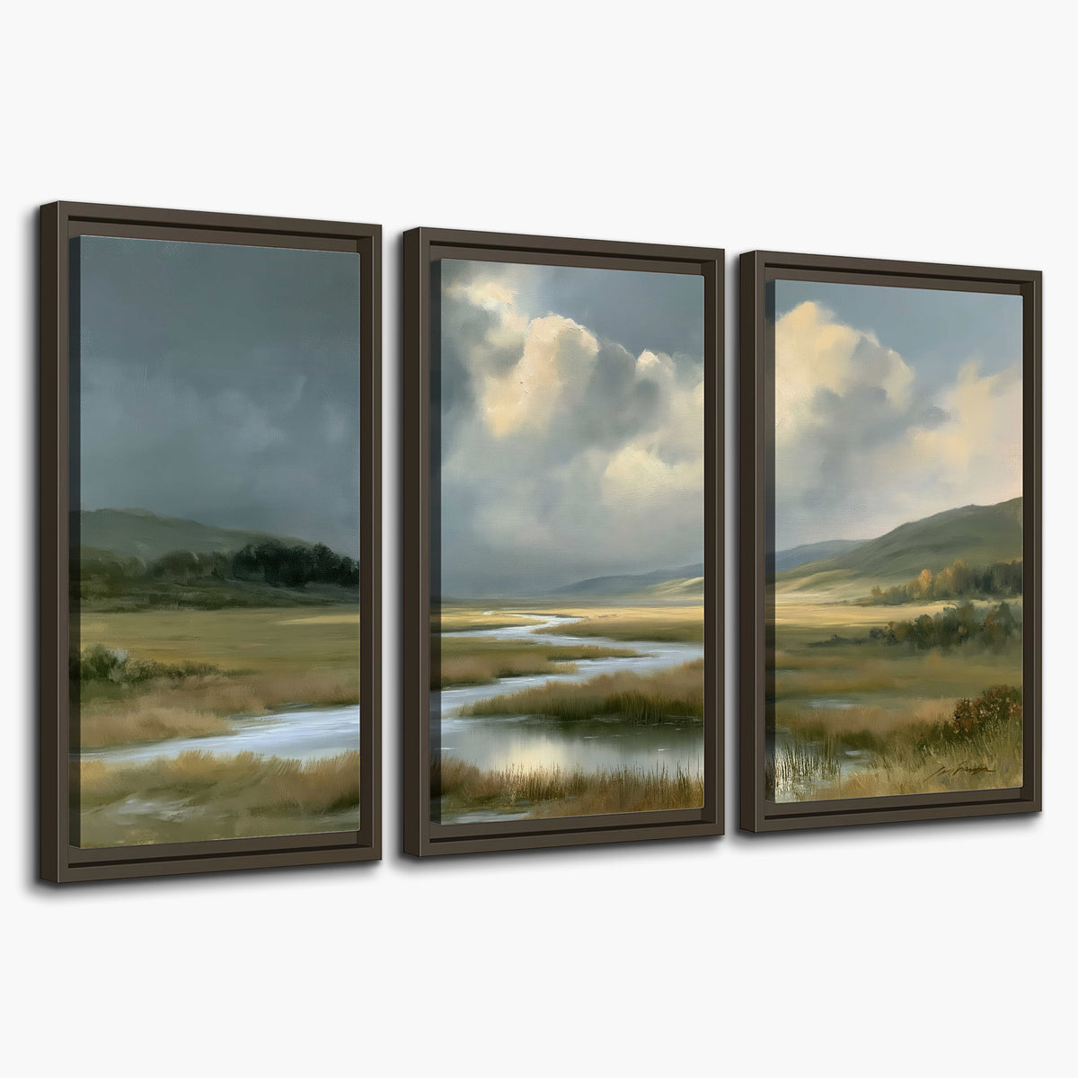 A winding stream through an open meadow beneath large sunlit clouds 3 piece framed canvas wall art on a white background