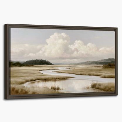 A pale winding waterway crossing quiet wetlands beneath billowing white clouds single framed canvas wall art on a white background