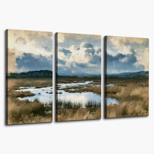 A wide open marsh with blue water and warm grasses beneath layered clouds 3 piece canvas wall art on a white background