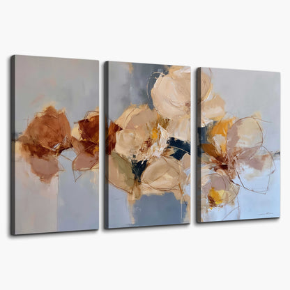 Loose ivory and ochre flower forms layered over a pale blue painterly background 3 piece canvas wall art on a white background