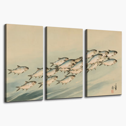 A flowing school of small fish above pale blue water on a cream ground 3 piece canvas wall art on a white background