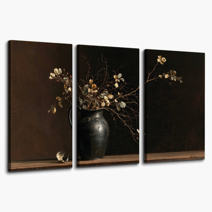 Fine flowering branches in a small dark vase on a wooden table against a deep brown background 3 piece canvas wall art on a white background