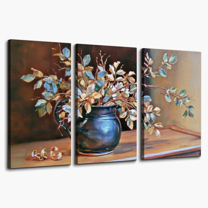 White and peach flowering branches arranged in a blue vase against a warm ochre background 3 piece canvas wall art on a white background