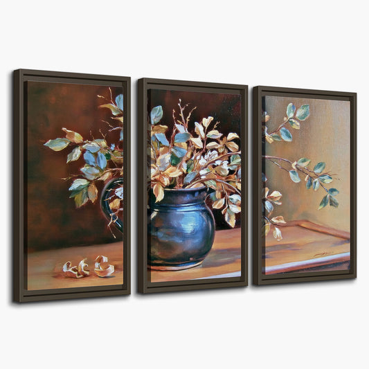 White and peach flowering branches arranged in a blue vase against a warm ochre background 3 piece framed canvas wall art on a white background