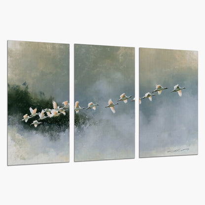 A flock of white birds flying low above a quiet blue-green lake set of 3 poster prints on a white background