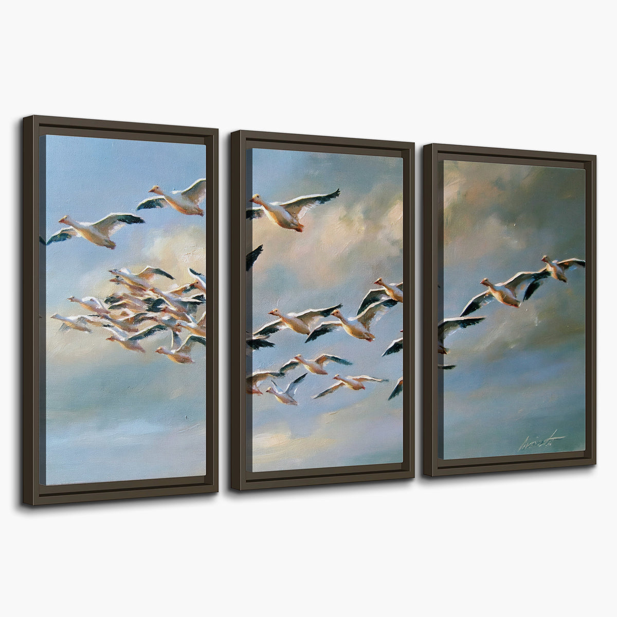A flock of pale seabirds gliding beneath soft clouds across a blue sky 3 piece framed canvas wall art on a white background