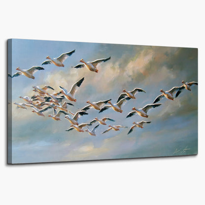 A flock of pale seabirds gliding beneath soft clouds across a blue sky single canvas wall art on a white background