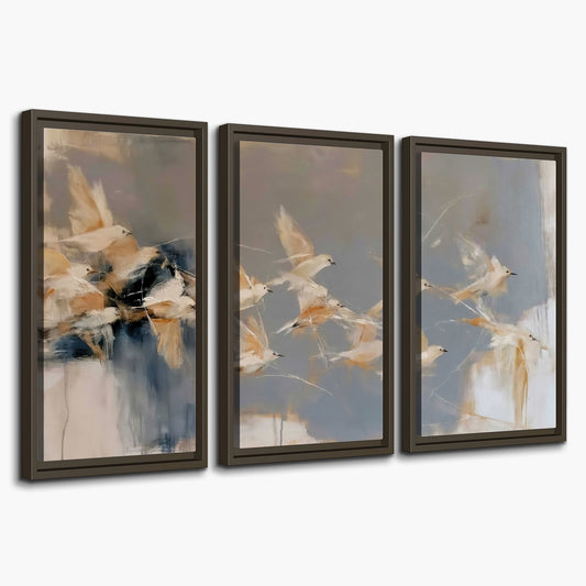 Pale bird-like forms sweeping across layered strokes of blue, ochre and cream 3 piece framed canvas wall art on a white background