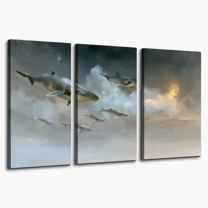 Whales drifting through pale dreamlike clouds toward a golden moon 3 piece canvas wall art on a white background