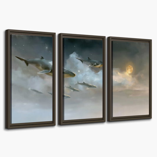 Whales drifting through pale dreamlike clouds toward a golden moon 3 piece framed canvas wall art on a white background